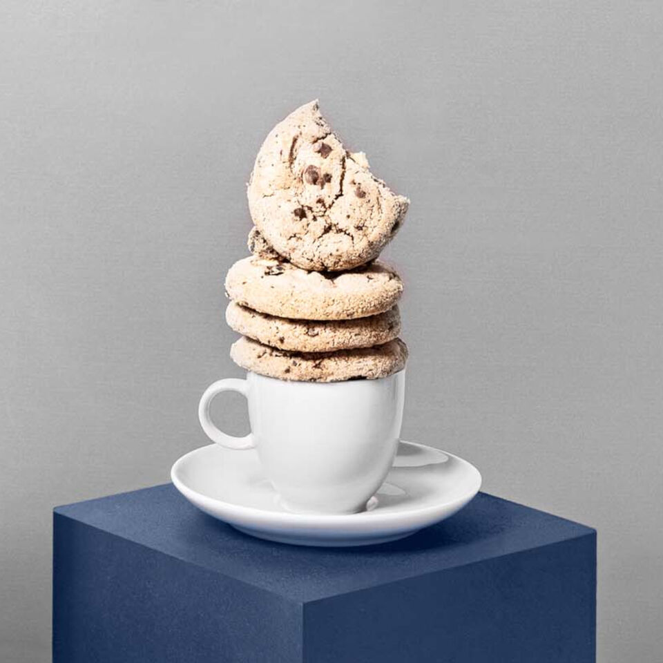 everal cookies stacked on a white teacup from the Thomas Sunny Day White collection