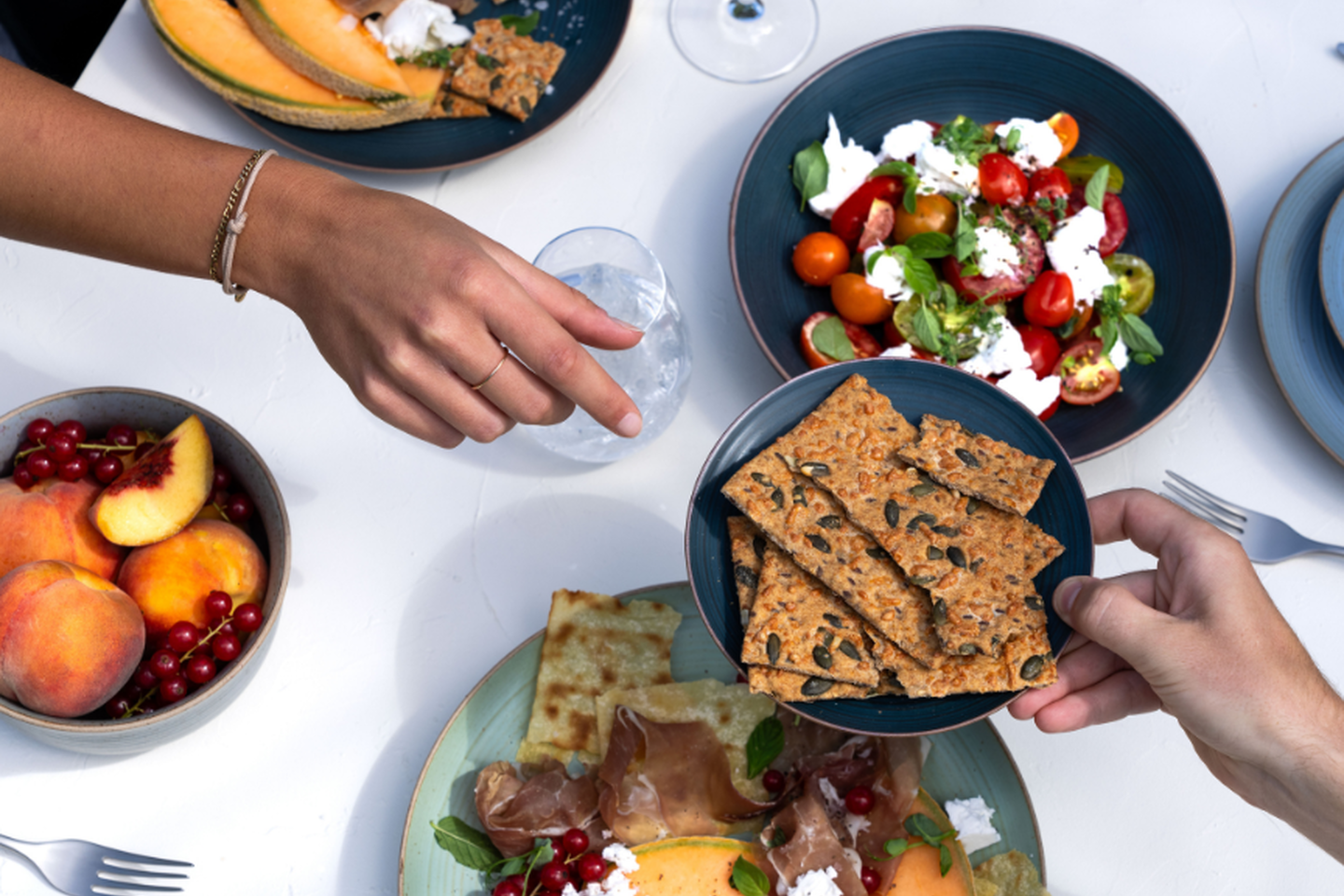 Barbecue table with melon, salad, antipasti and Thomas tableware in the sun