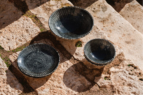 Thomas Sandora darkblue items on stone steps in sunlight