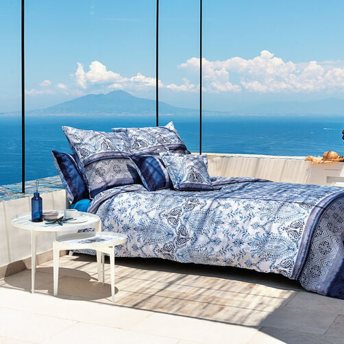 Bassetti bed linen in blue with Mediterranean pattern on terrace with sea view