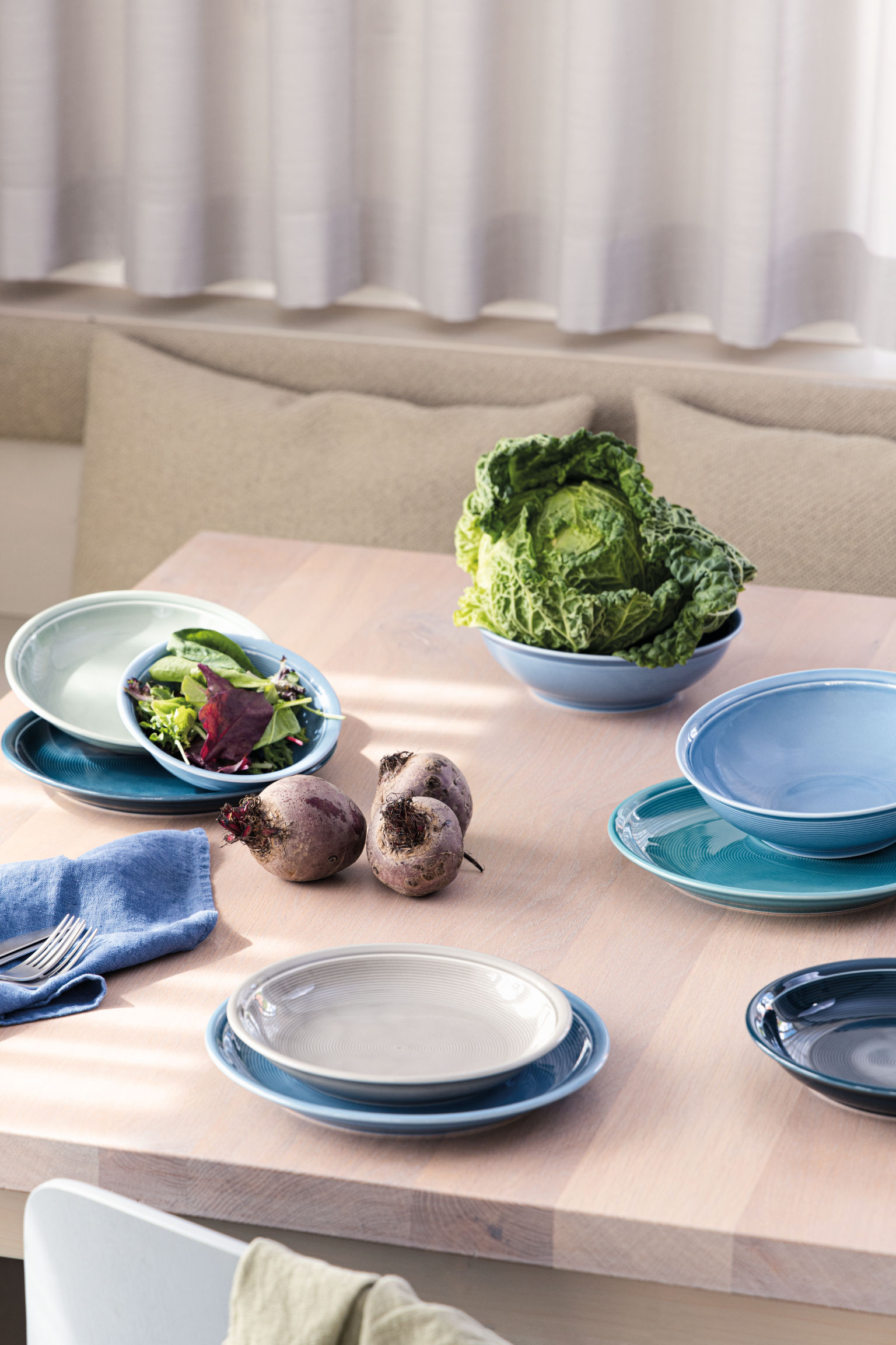 Thomas Trend set table with different plates and beetroots and cabbage as decoration