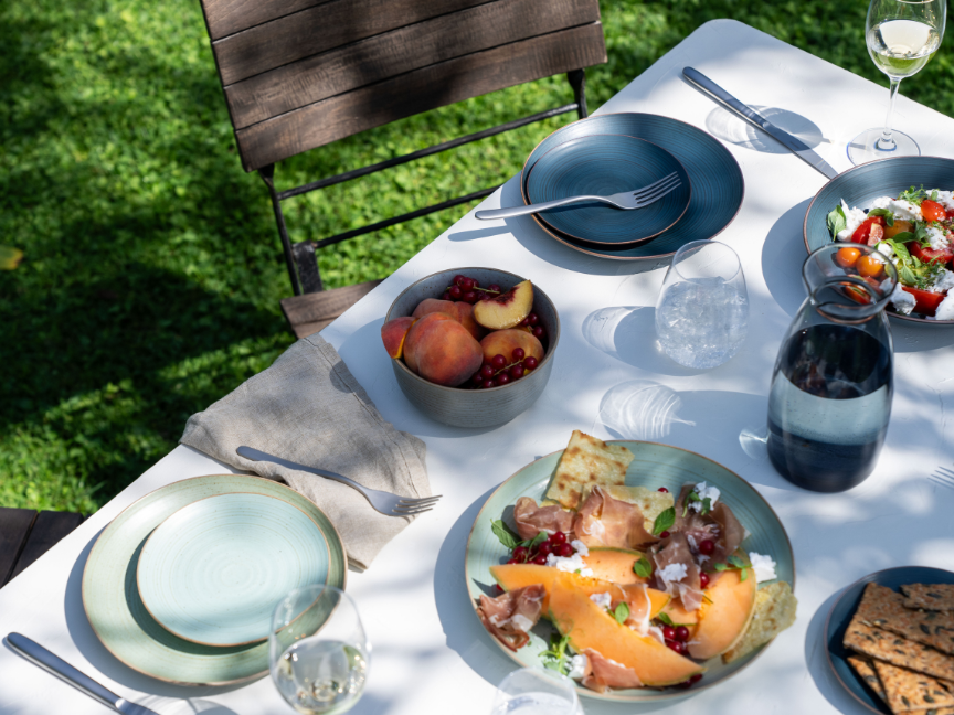 Garden table set with Thomas tableware, melon salad and summer fruit
