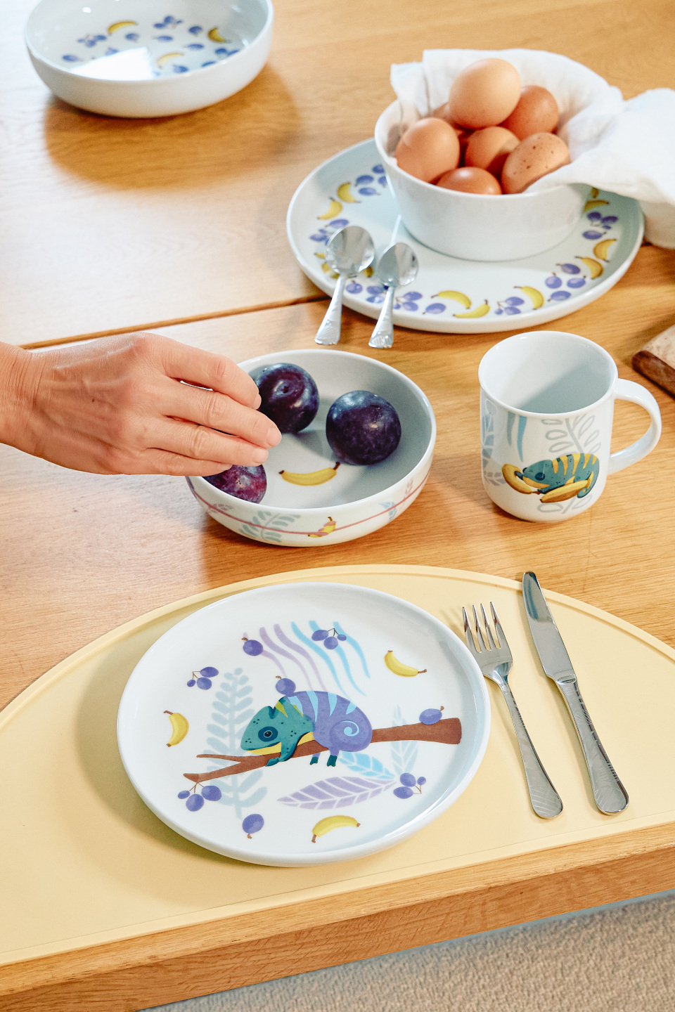 Thomas Kids tableware with eggs in a bowl on wodden table
